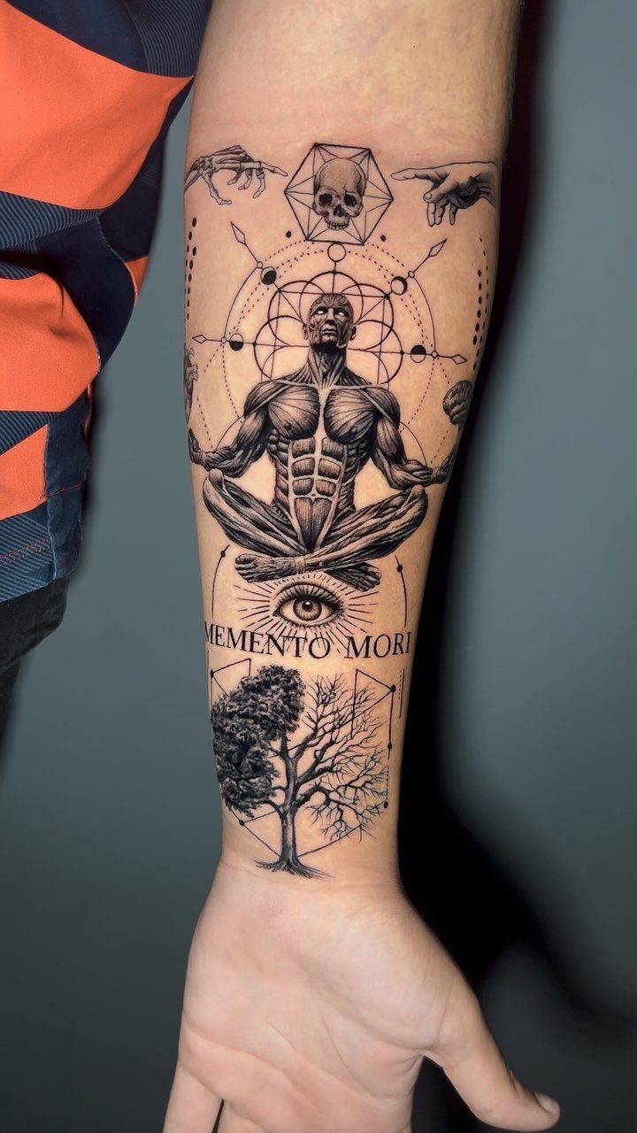 Forearm tattoo featuring a meditative figure with geometric symbols and a tree.