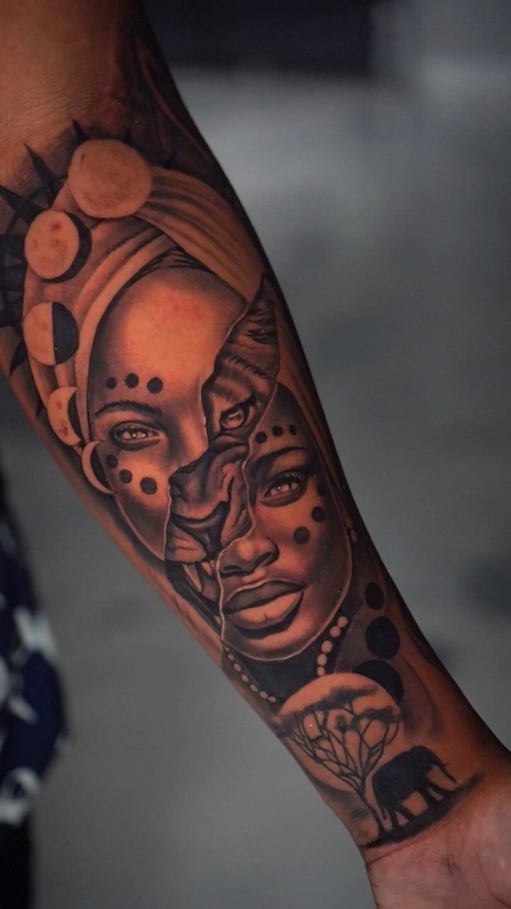 Detailed black and grey tattoo of a woman and lion on brown skin.