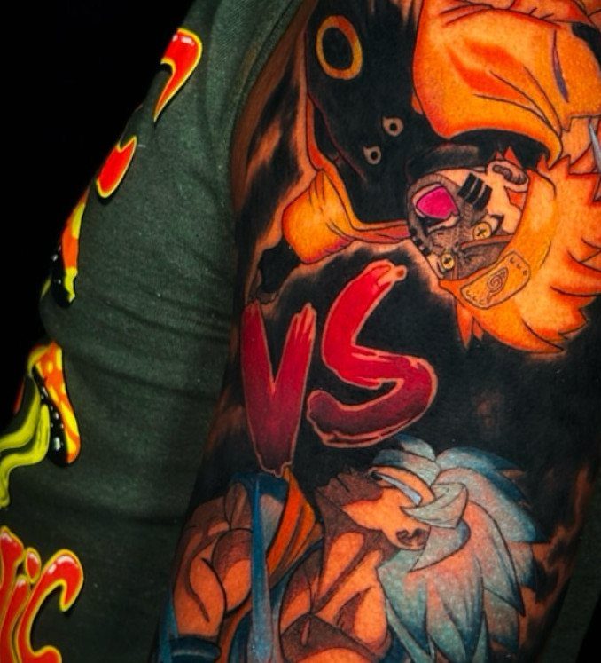 Colorful anime tattoo featuring Naruto and Goku on brown skin with a red VS.