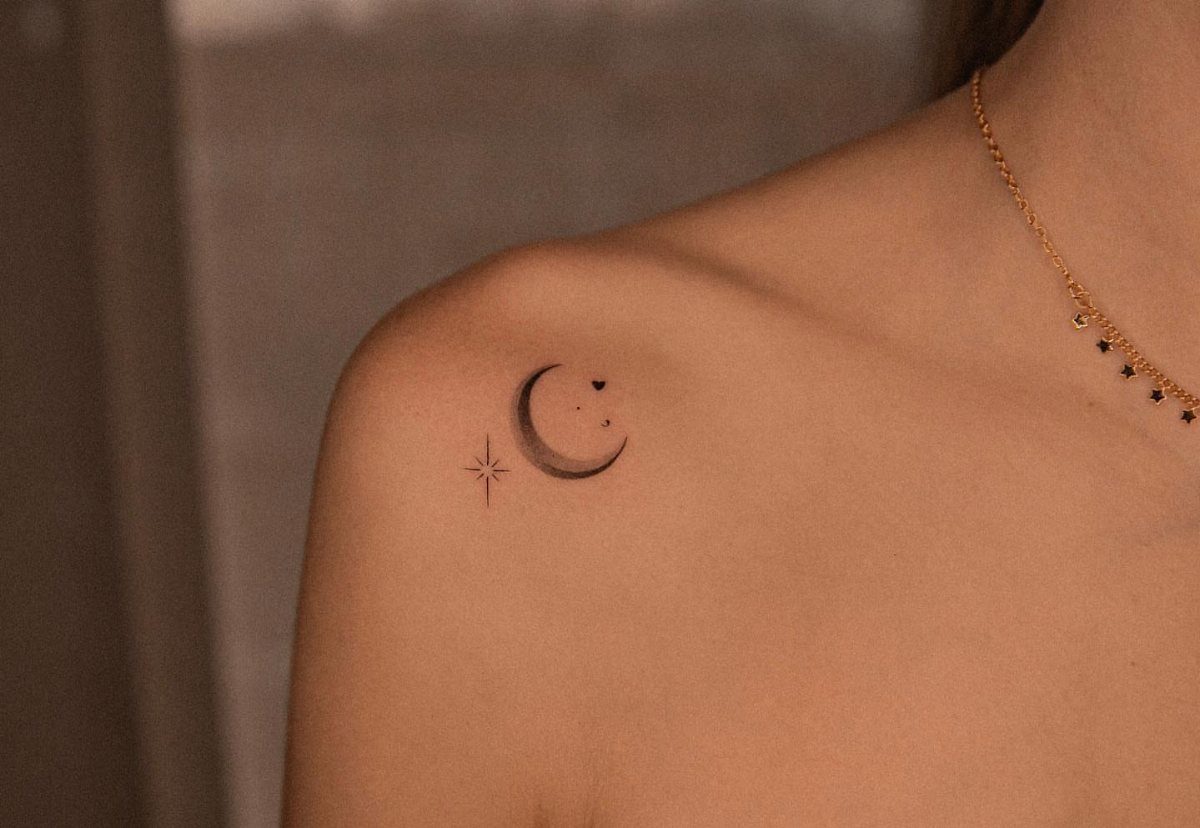 Crescent moon and star tattoo on a person's shoulder