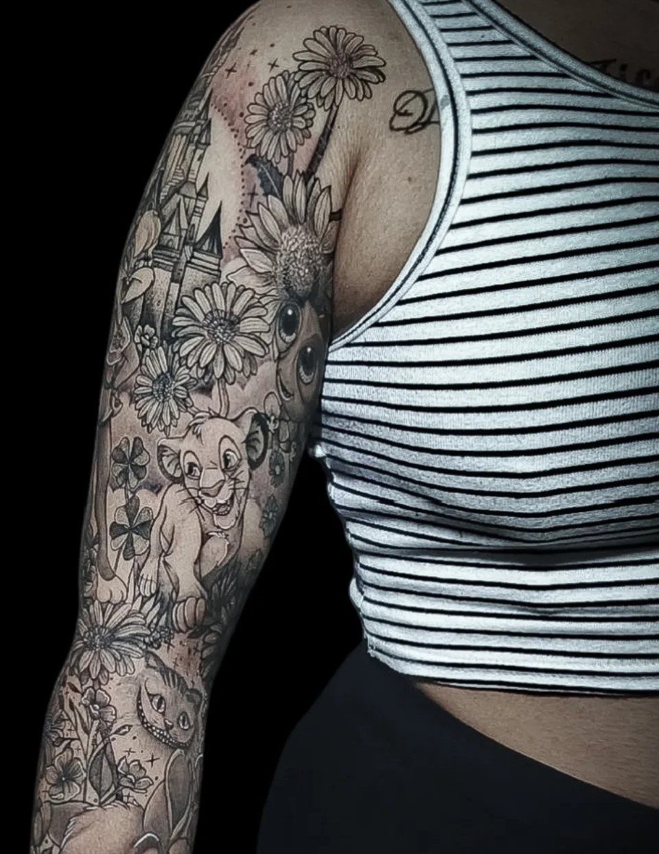 Disney character tattoo sleeve with Simba and Cheshire Cat mixed with large daisies.