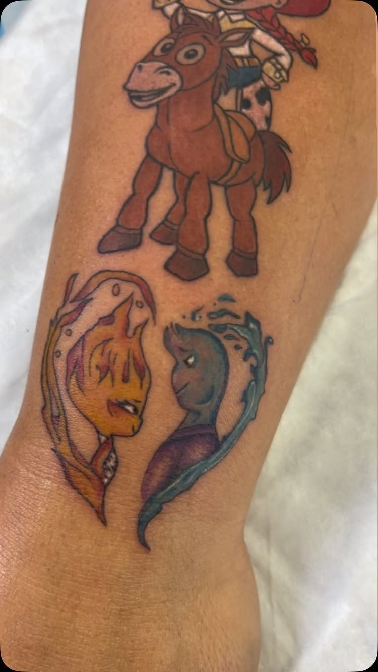 Colorful Disney character tattoos on an arm featuring Bullseye, Ember, and Wade.