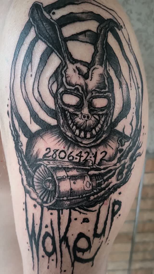 Donnie Darko tattoo featuring Frank the rabbit, a jet engine, and Wake Up text.