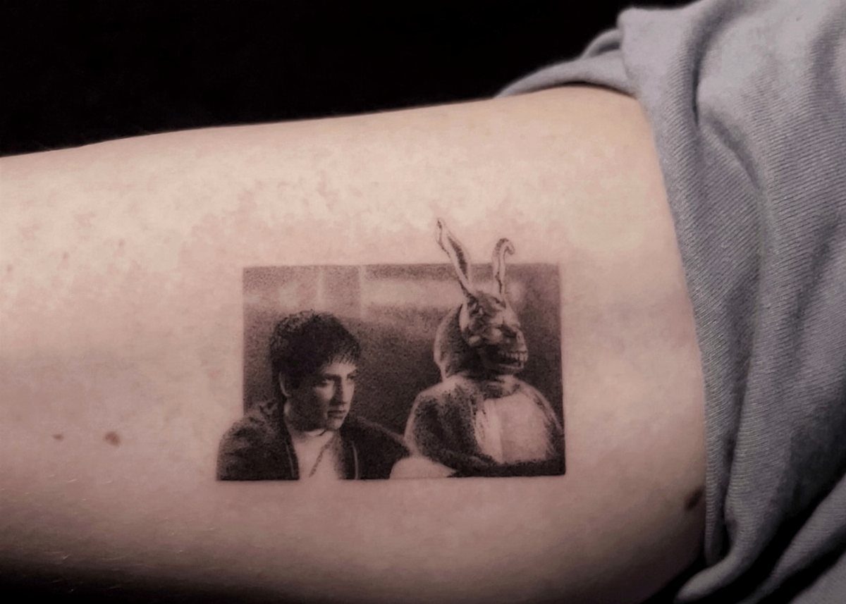 Donnie Darko portrait tattoo on skin featuring the main character and Frank the rabbit