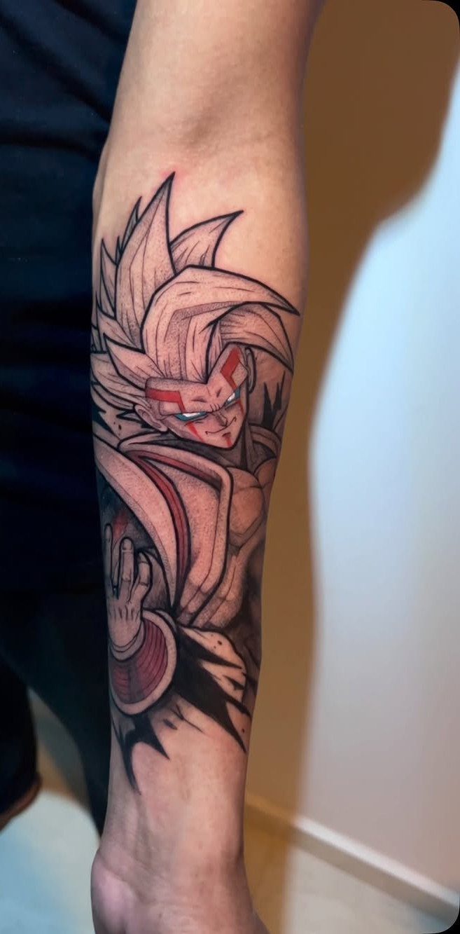 Baby Vegeta tattoo on a forearm with red facial markings and spiky hair.