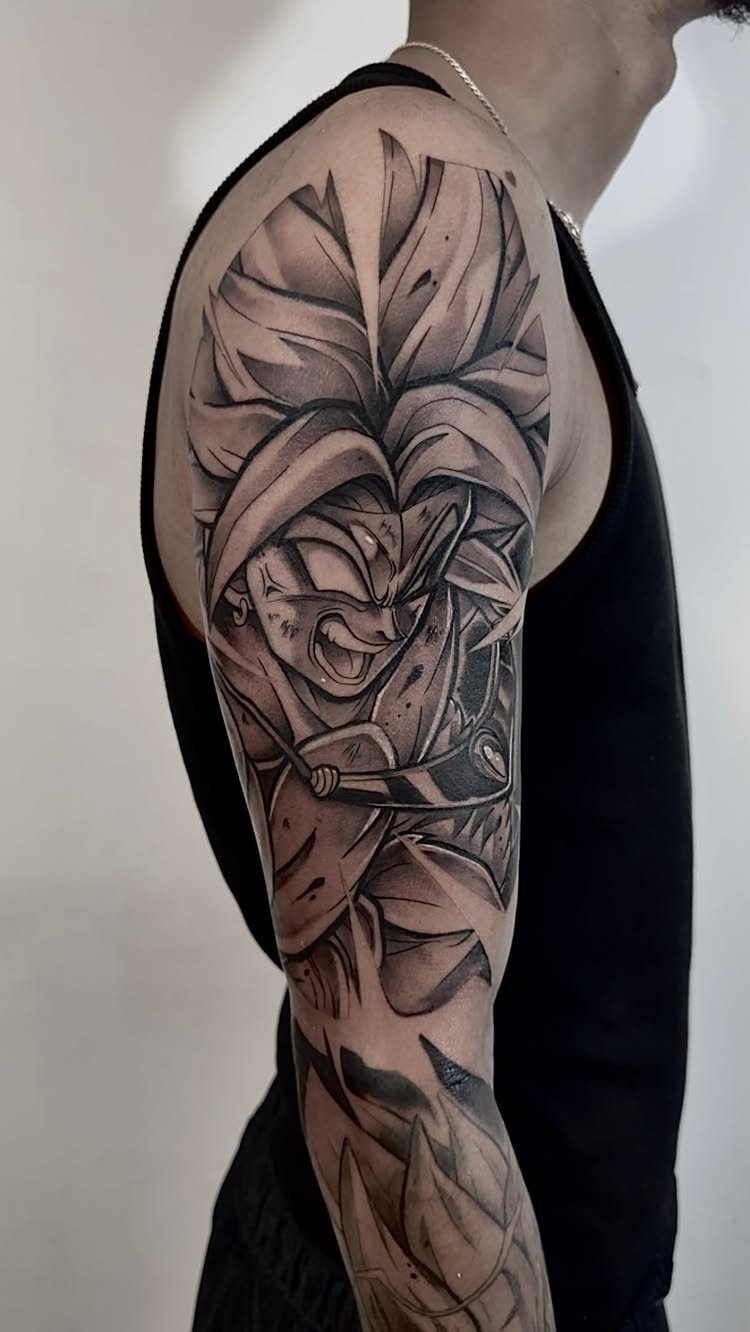 Broly tattoo on a man's upper arm and shoulder in black and grey ink
