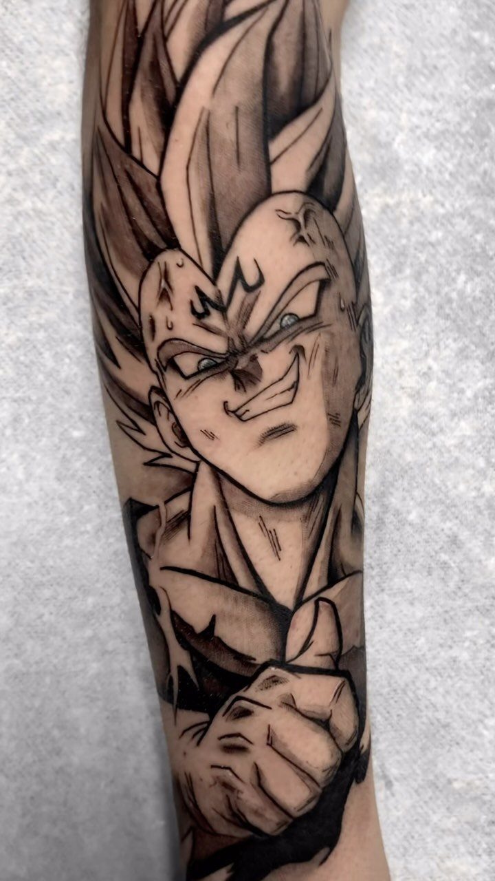 Majin Vegeta tattoo on an arm with the M symbol on his forehead.