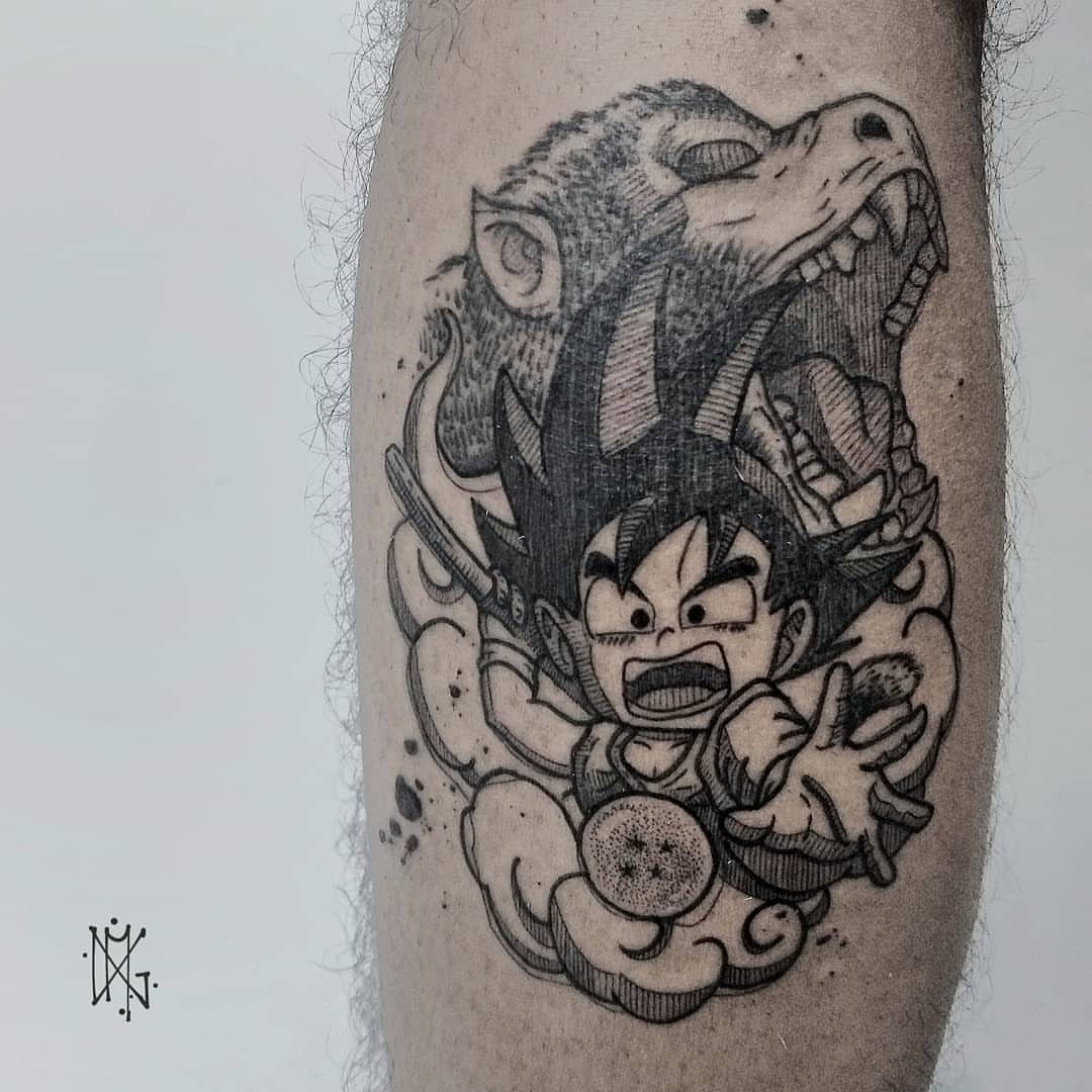 Tattoo of young Goku and a roaring Great Ape on a person's leg.
