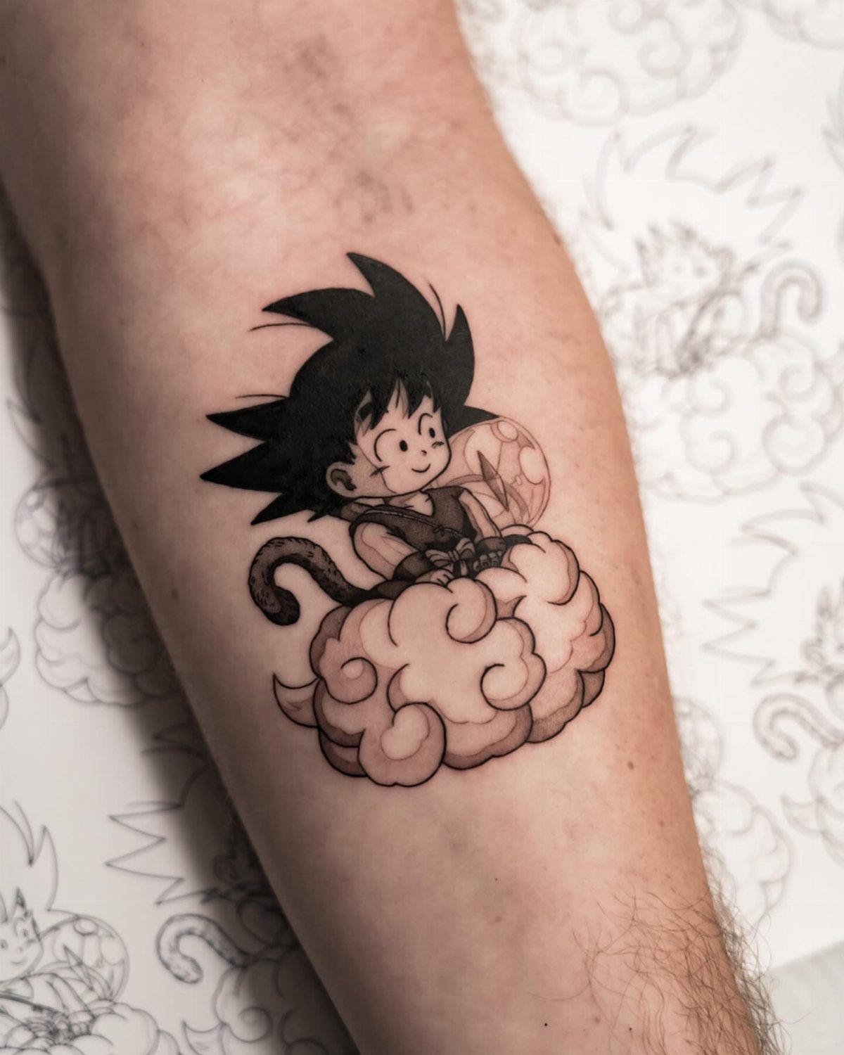 Young Goku tattoo riding a flying nimbus cloud and holding a dragon ball
