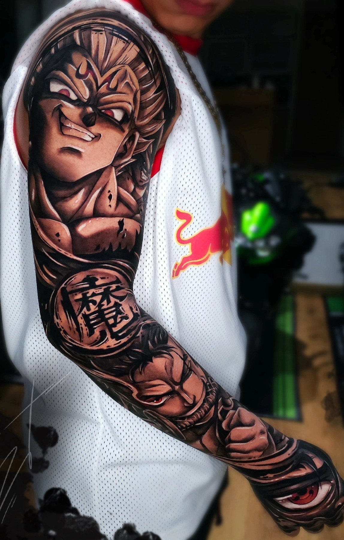 Sleeve tattoo featuring Goku and other Dragon Ball characters on a person's arm.