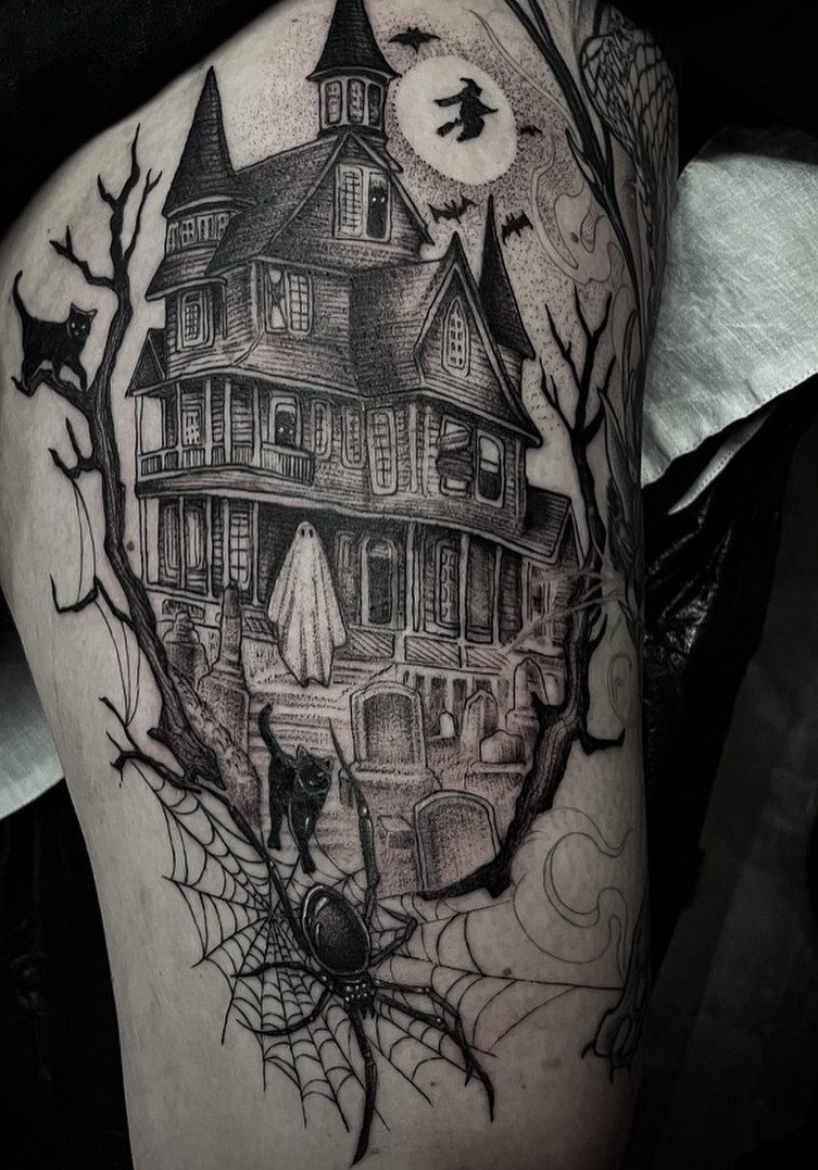 Blackwork tattoo of a haunted Victorian house with a ghost and graveyard on skin.