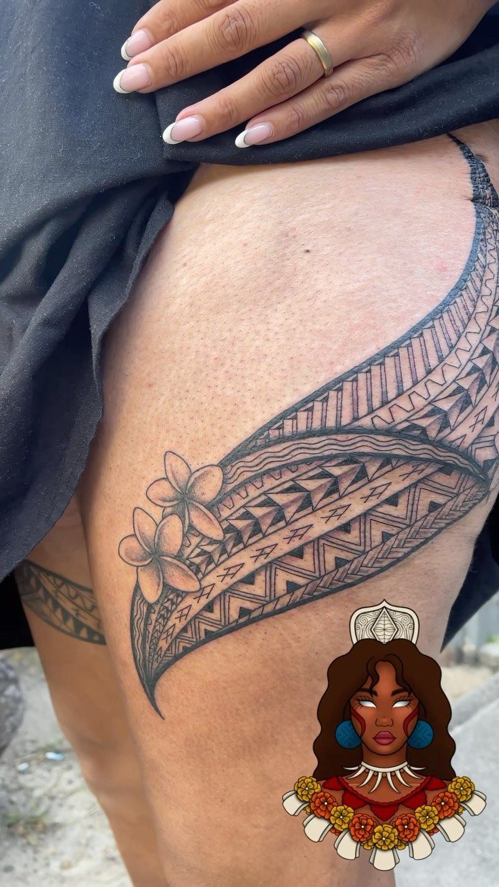 Tribal leg band tattoo with plumeria flowers on a person's upper thigh.