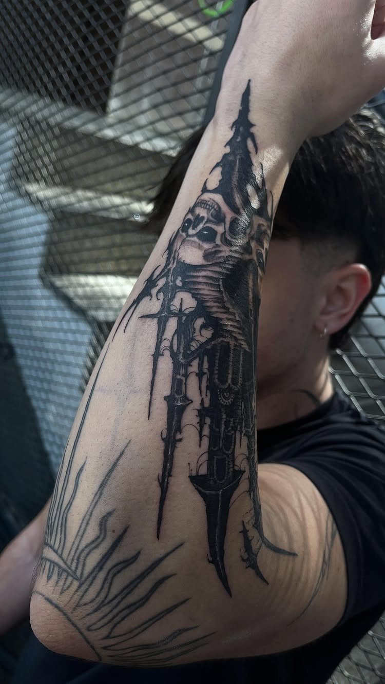 Gothic cathedral tattoo with a skull on a man's forearm