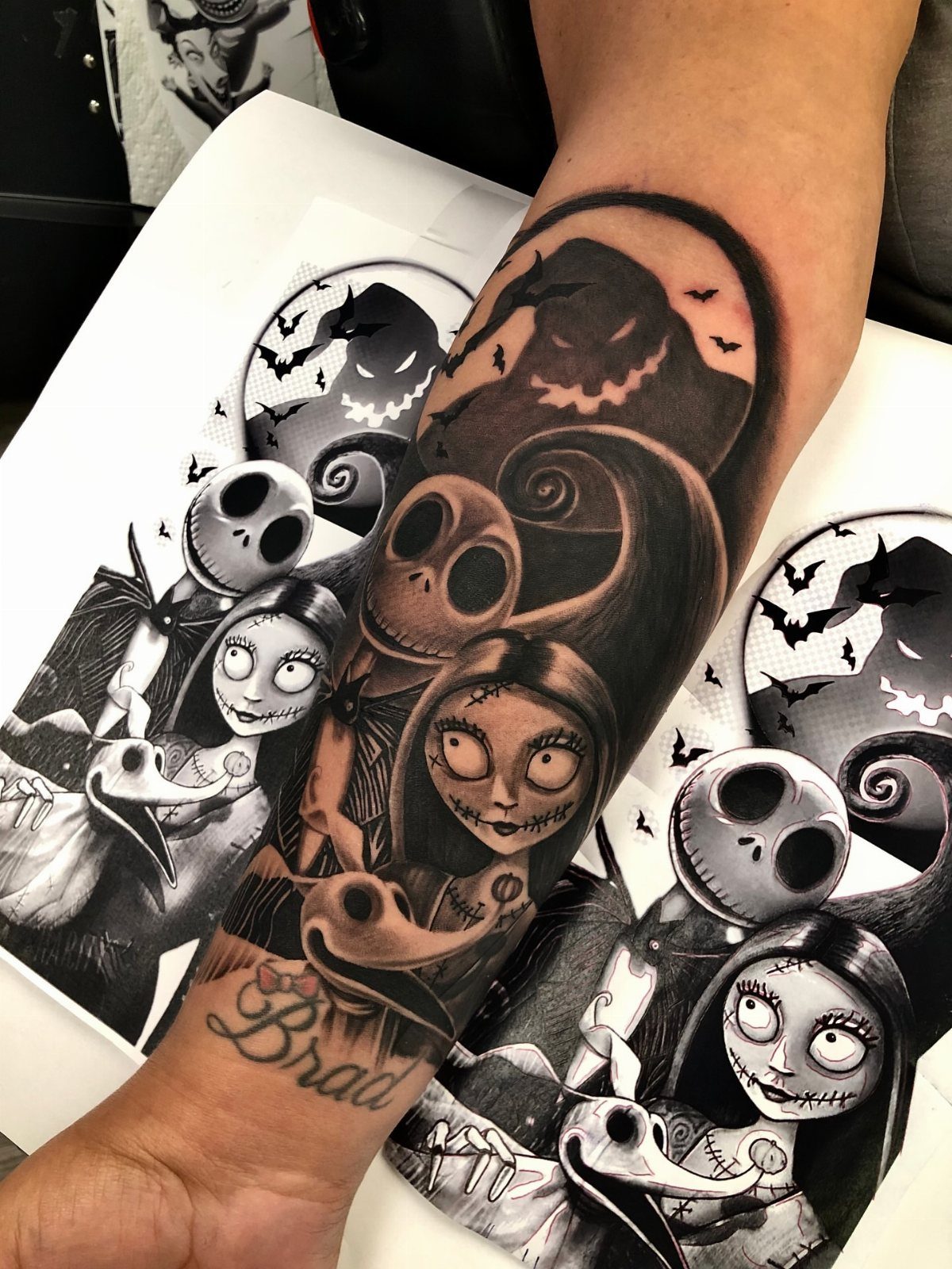 Nightmare Before Christmas tattoo of Jack and Sally on a person's forearm.