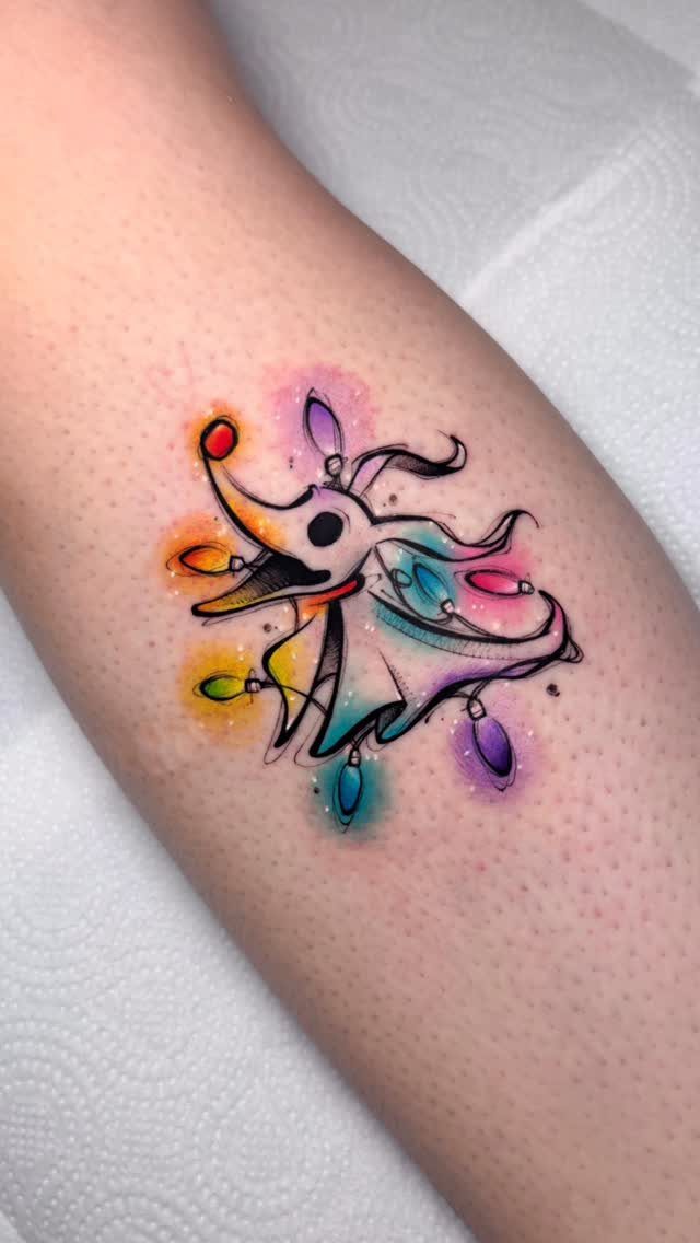 Zero the ghost dog tattoo wrapped in colorful Christmas lights on skin
