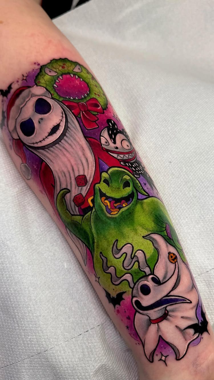 Colorful forearm tattoo featuring Jack Skellington, Oogie Boogie, and Zero from The Nightmare Before Christmas.