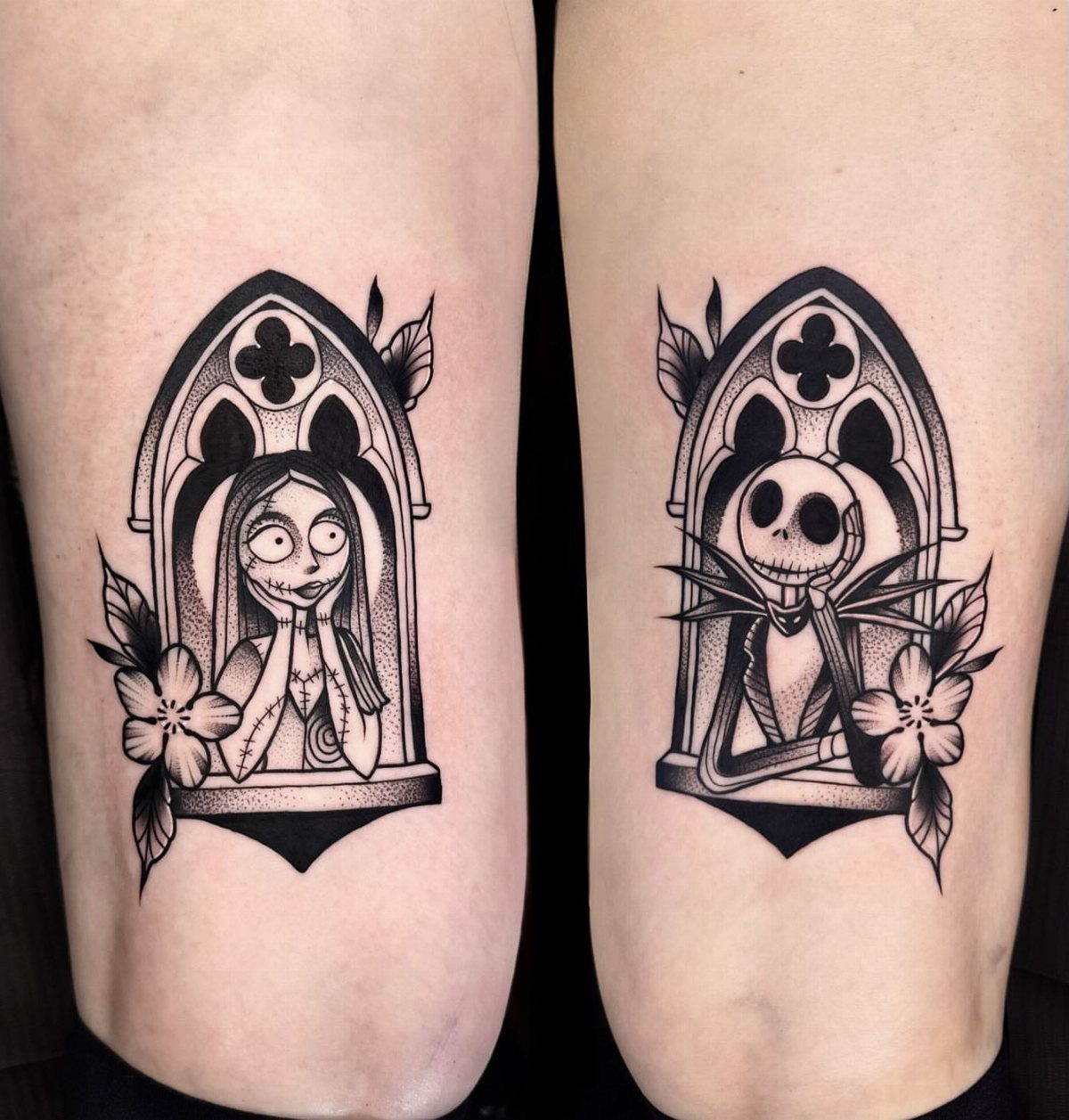 Black and white tattoos of Sally and Jack Skellington in gothic window frames.