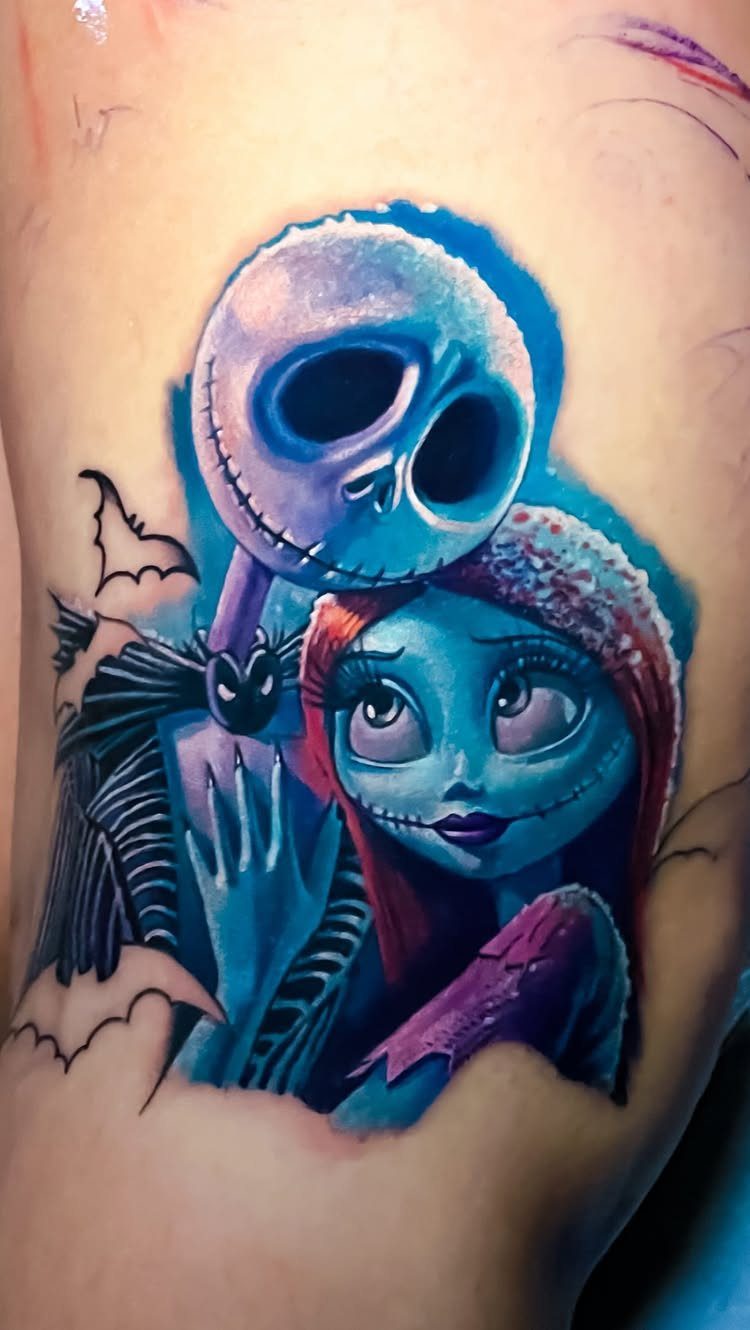 Jack Skellington and Sally tattoo with vibrant blue and purple colors on skin