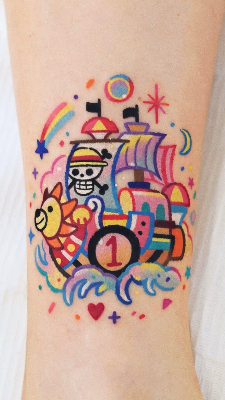 Colorful tattoo of a stylized pirate ship train with a Straw Hat skull.