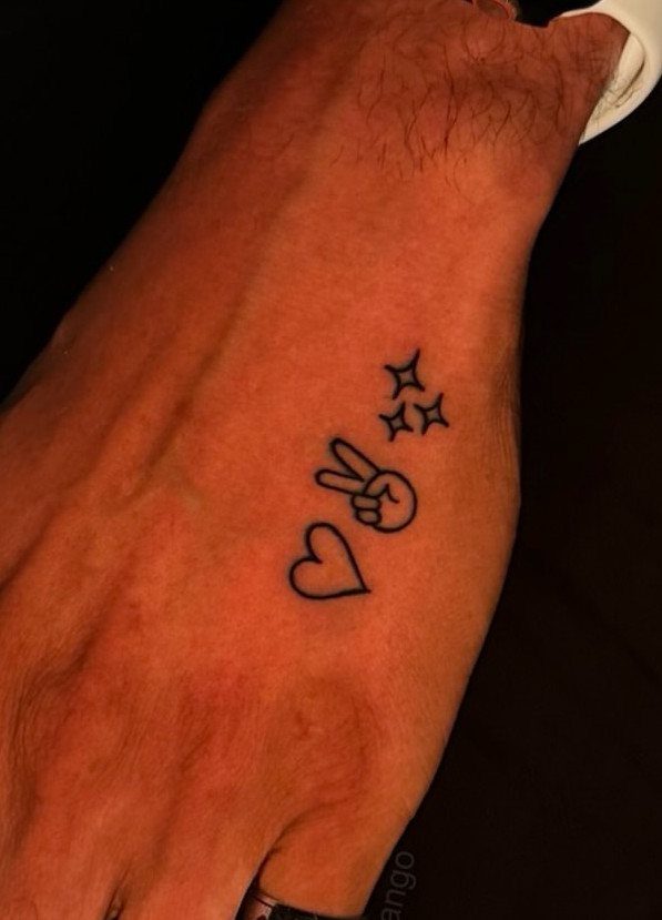 Hand tattoos featuring a heart, a peace sign hand gesture, and small stars.