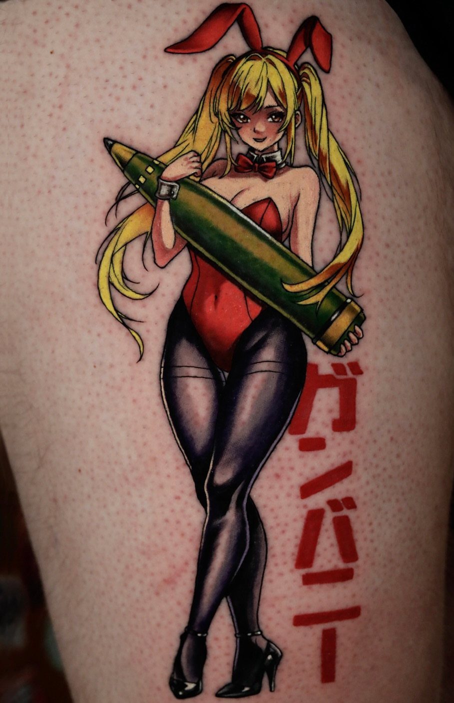 Anime woman in red bunny suit tattoo holding a large green pencil