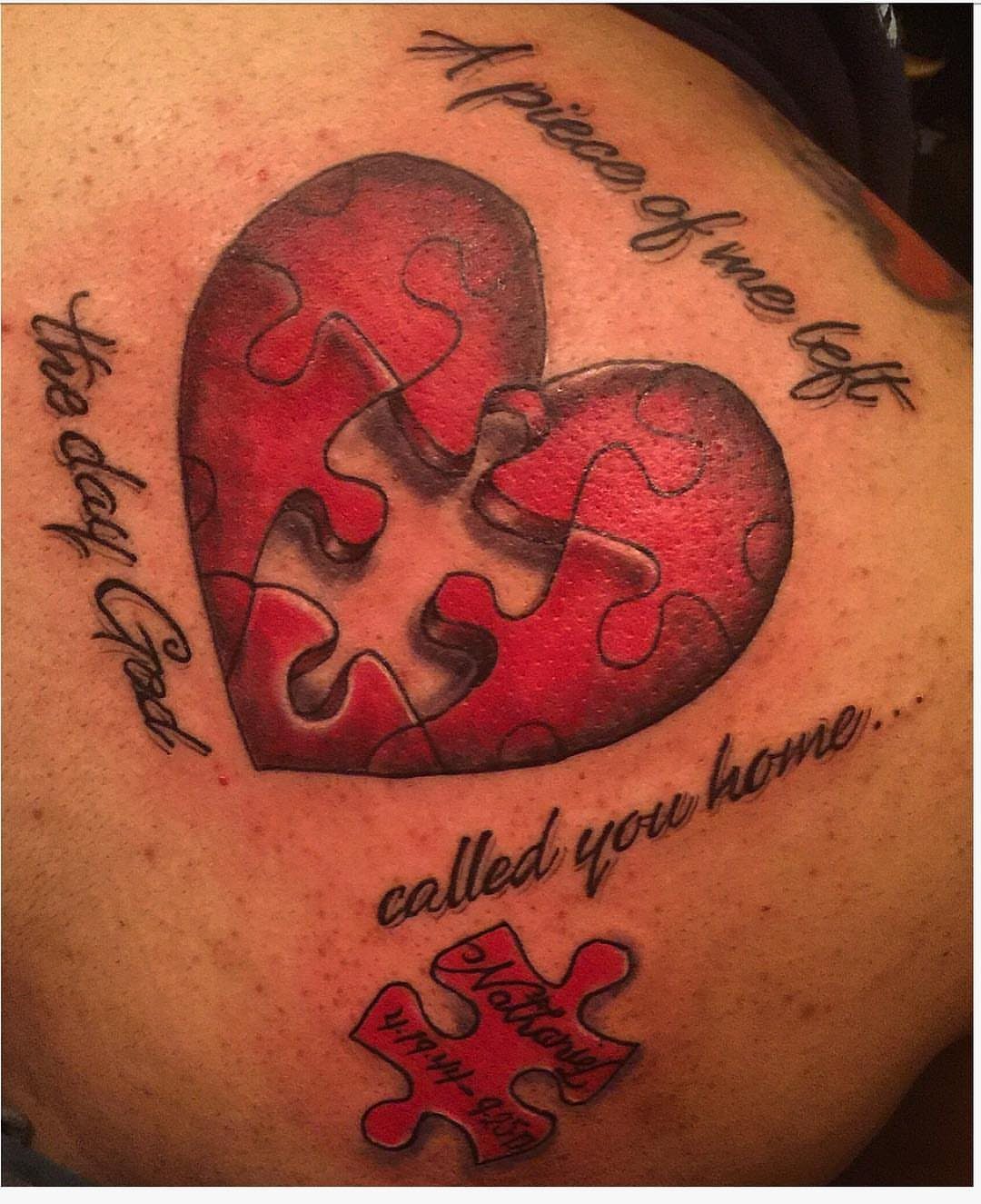 Red heart puzzle piece tattoo with a missing center and memorial text.