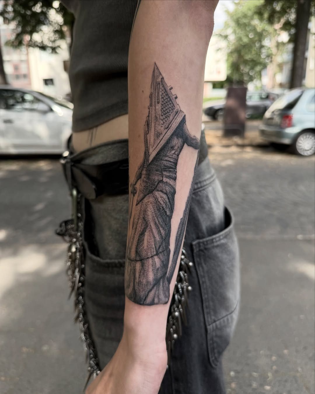 Pyramid Head tattoo on a forearm featuring the character's iconic helmet and apron.