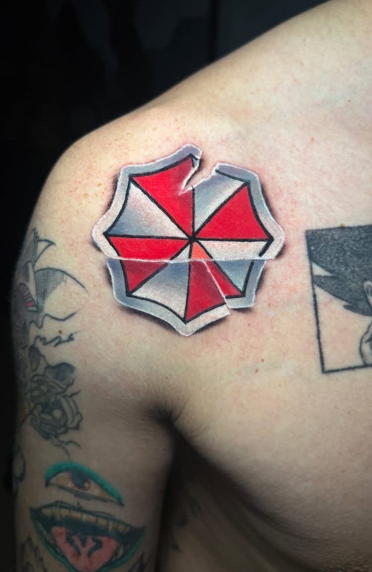 Umbrella Corporation logo tattoo on a shoulder designed as a peeling sticker