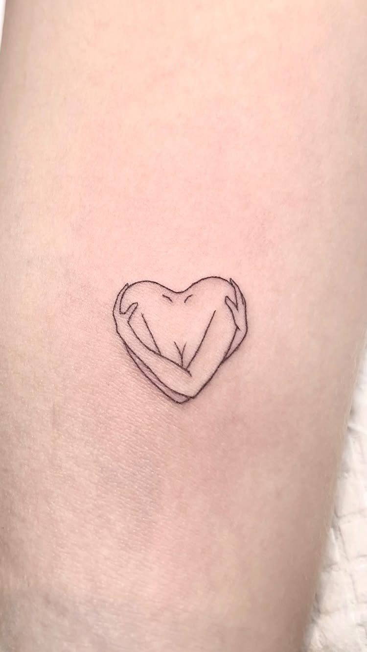 Minimalist black ink tattoo of arms hugging a body in a heart shape