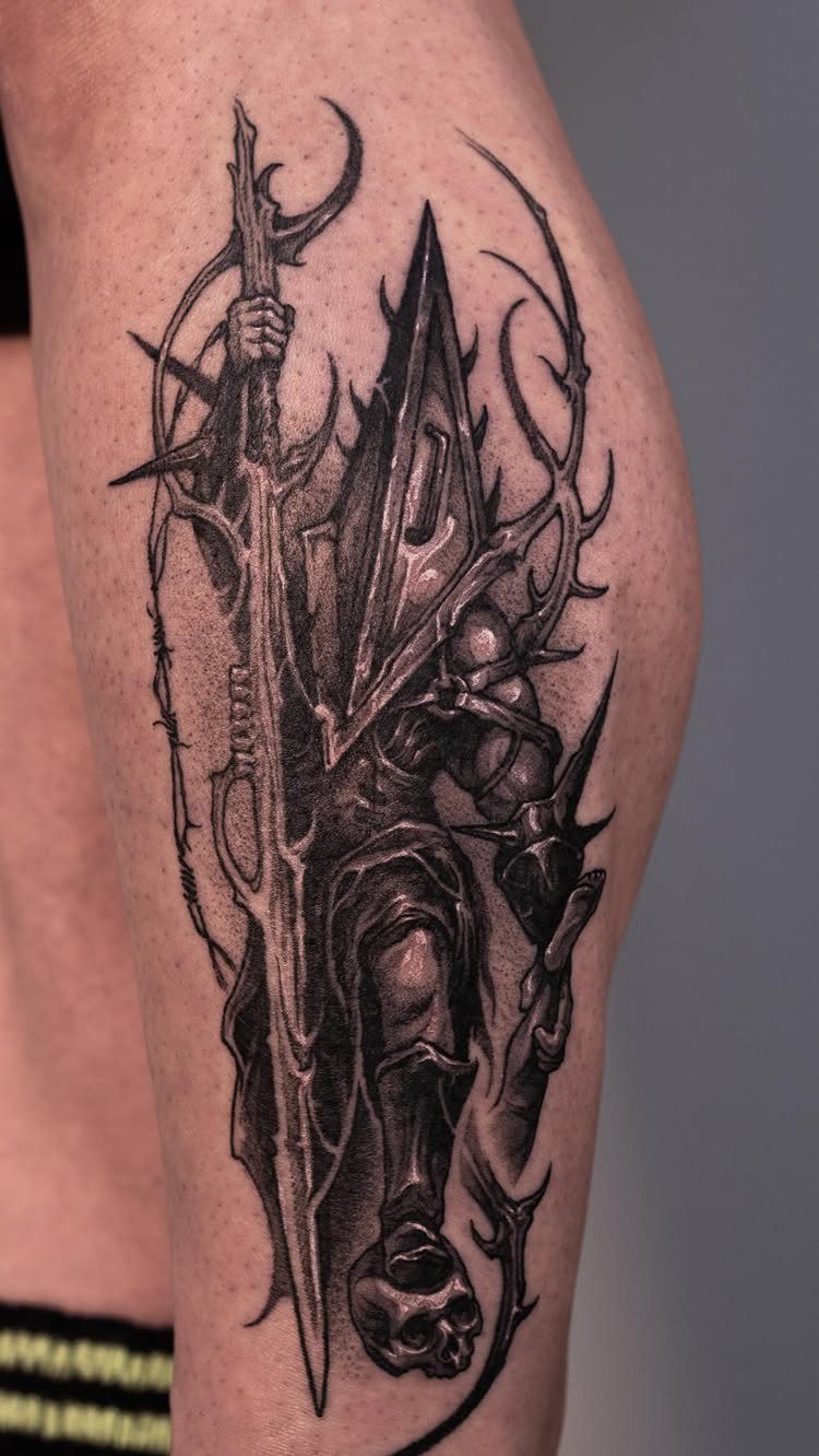 Pyramid Head tattoo on an arm featuring the monster with his signature great knife.