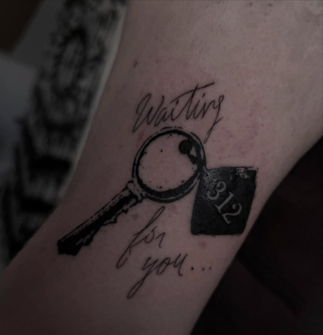 Key tattoo with room 312 tag and Waiting for you text on skin