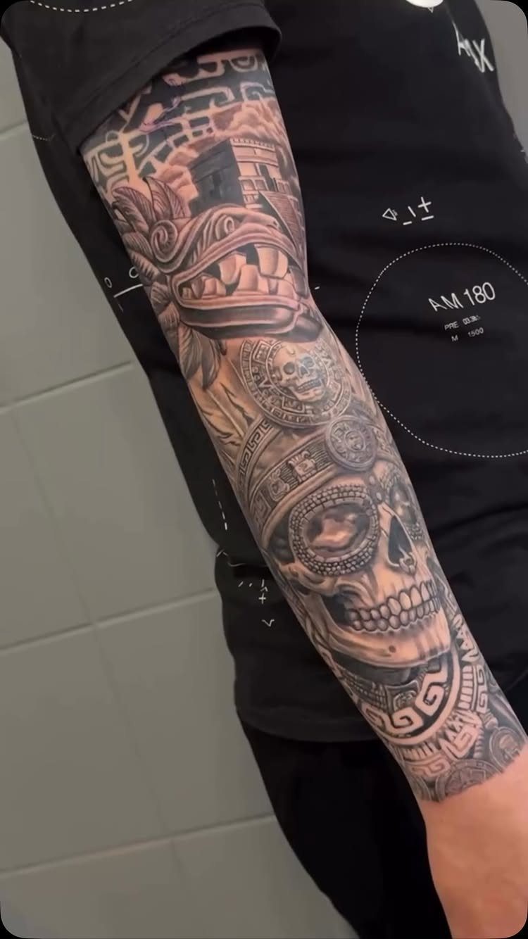 Aztec warrior sugar skull tattoo on a forearm with intricate grey shading