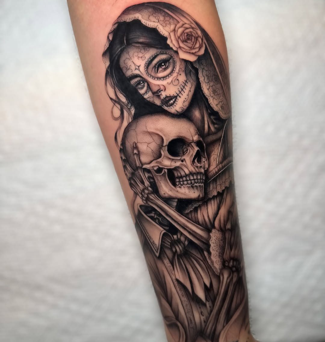 Black and grey tattoo of a sugar skull woman and a human skull
