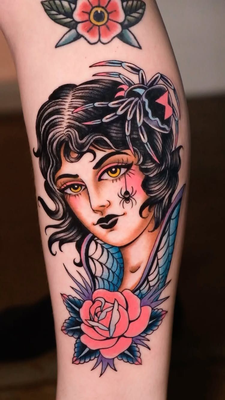 Traditional tattoo of a woman's head with spiders and a pink rose on skin